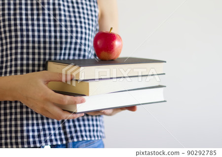 拿著書和蘋果的婦女的上身 90292785