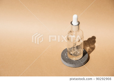 Dropper glass Bottle Mock-Up on beige cosmetic podium. Body treatment and spa. Natural beauty products. Eco cream, serum, skin care blank bottle. Anti-cellulite massage oil. Oily cosmetic pipette 90292908