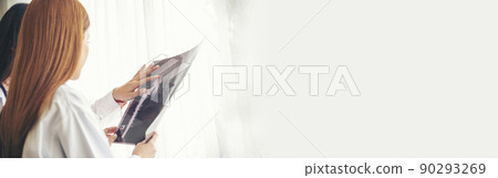 Banner Two asian women doctors discuss meeting office medical clinic. Young asian female doctor looking x-ray film consulting patient disease together. Panorama Asian medical care lab with copy space 90293269