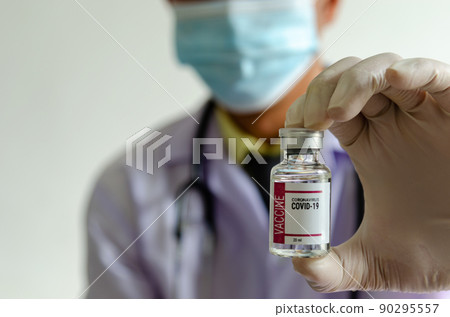 Doctor or scientist holding a bottle of covid vaccine. 90295557