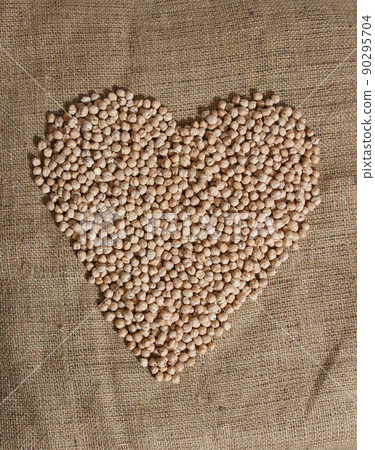 Pile of Chickpeas in Shape of Heart on Burlap Bag Pile of Chickpeas in Shape of Heart on Burlap Bag 90295704