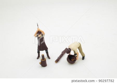 a mini of worker splitting wood with an axe. a mini of worker splitting wood with an axe. 90297782