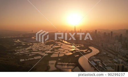 Shenzhen skyline , with skyscrapers and office against fish farm or fish ponds, during dramatic moment in evening, from the view of boundary of Hong Kong suburb where is named Ma Tao Lung Shenzhen skyline , with skyscrapers and office against fish farm or fish ponds, during dramatic moment in evening, from the view of boundary of Hong Kong suburb where is named Ma Tao Lung 90299237