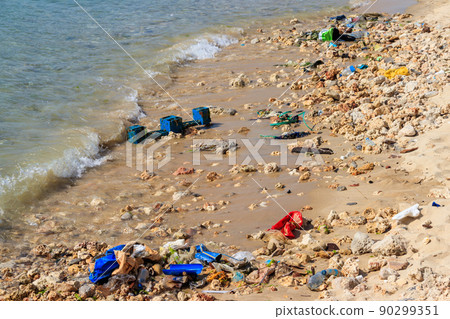 Garbage on a bank of ocean. Pollution of sea, ocean water with waste, plastics garbage. Concept of pollution of ocean, sea and river coastline with plastic trash Garbage on a bank of ocean. Pollution of sea, ocean water with waste, plastics garbage. Concept of pollution of ocean, sea and river coastline with plastic trash 90299351