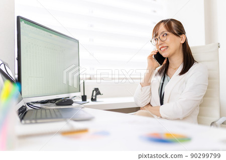 Calling a young female engineer working from home Calling a young female engineer working from home 90299799