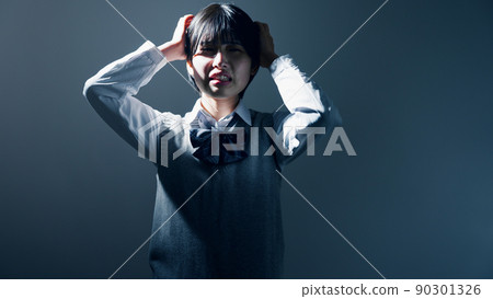 High school girl holding her head High school girl holding her head 90301326