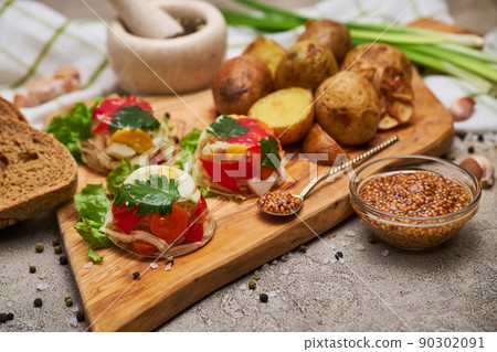 Portion of delicious chicken aspic on serving board on concrete table Portion of delicious chicken aspic on serving board on concrete table 90302091