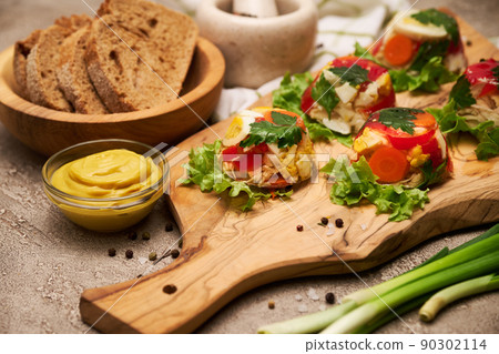 Portion of delicious chicken aspic on serving board on concrete table 90302114