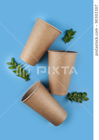 Disposable paper biodegradable cups and green leaves 90303307
