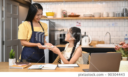 Loving asian mom her little sweet daughter in home kitchen. Family, children, love and happy people concept Loving asian mom her little sweet daughter in home kitchen. Family, children, love and happy people concept 90304443