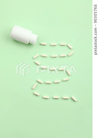 creative concept of medical pills on a green background 90305768