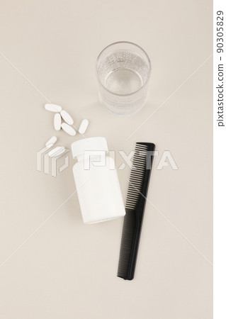 hair brush and pills, white background, medical creative concept photo 90305829