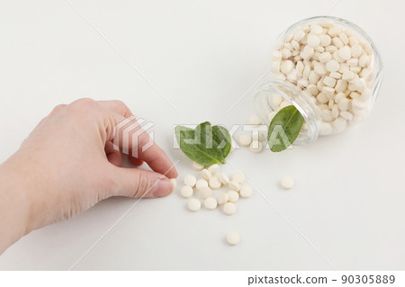 hand motion picking pills, white background, medical creative concept photo 90305889