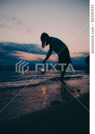 The silhouette of a high school girl in uniform and the beautiful sunset sky 90305935
