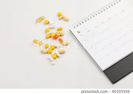 table clock, pills, white background, medical creative concept photo 90305936