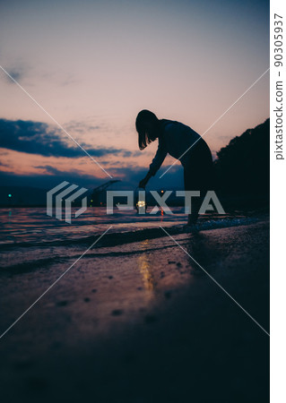 The silhouette of a high school girl in uniform and the beautiful sunset sky 90305937
