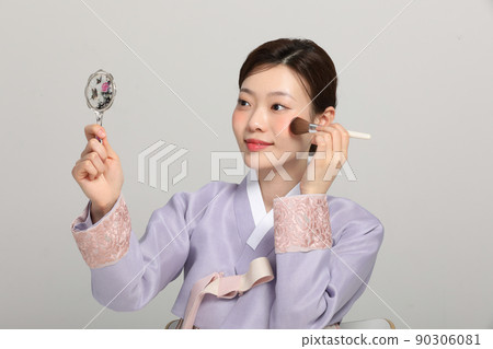 spring beauty concept, beautiful korean woman wearing hanbok with holding a brush spring beauty concept, beautiful korean woman wearing hanbok with holding a brush 90306081