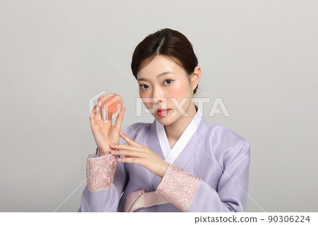 spring beauty concept, beautiful korean woman wearing hanbok with holding blusher spring beauty concept, beautiful korean woman wearing hanbok with holding blusher 90306224