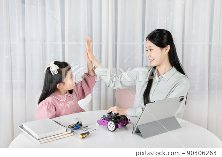 Asian Korean mother and daughter learn progamming coding on tablet 90306263