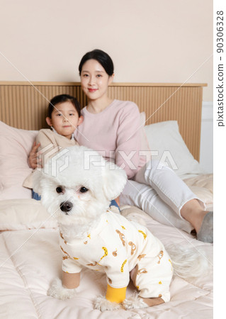 mother and daughter and dog sitting on the bed mother and daughter and dog sitting on the bed 90306328