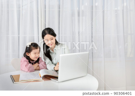 Asian Korean mother and daughter taking online classes on tablet Asian Korean mother and daughter taking online classes on tablet 90306401