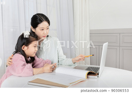 Asian Korean mother and daughter taking online classes on laptop Asian Korean mother and daughter taking online classes on laptop 90306553