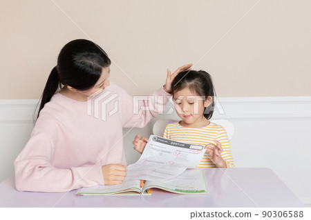 Asian Korean mom compliments while reading test papers 90306588