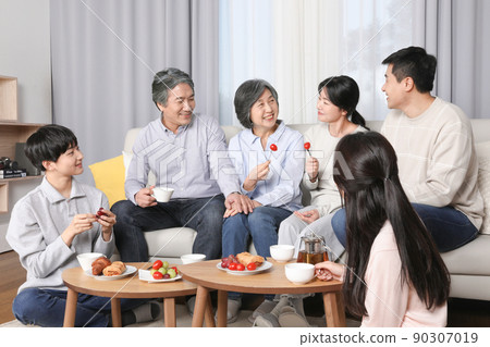 Asian Korean family_ enjoying tea time Asian Korean family_ enjoying tea time 90307019