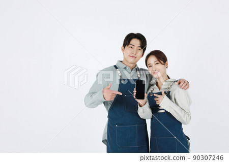 start up concept asian korean young woman and man holding smartphone start up concept asian korean young woman and man holding smartphone 90307246