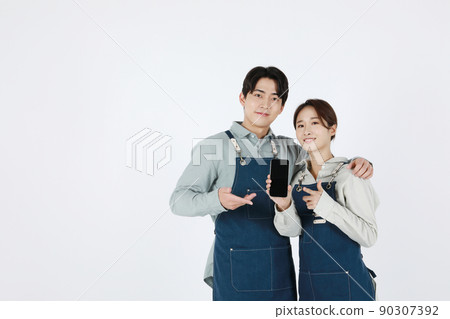 start up concept asian korean young woman and man holding a smartphone start up concept asian korean young woman and man holding a smartphone 90307392