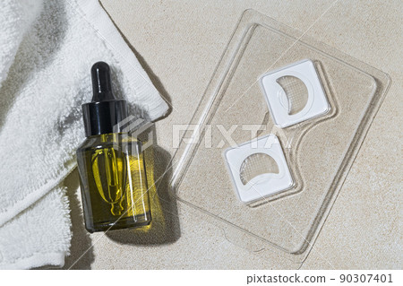 Cosmetic Microneedle eye Patches and bottle of serum or oil for daily routine before bed Cosmetic Microneedle eye Patches and bottle of serum or oil for daily routine before bed 90307401