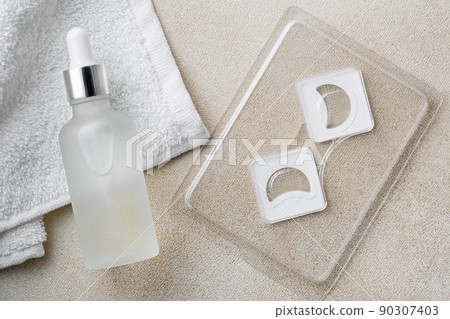 Cosmetic Microneedle eye Patches and bottle of serum or oil for daily routine before bed Cosmetic Microneedle eye Patches and bottle of serum or oil for daily routine before bed 90307403
