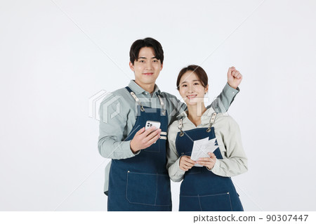 start up concept asian korean young woman and man holding a smartphone and receipt start up concept asian korean young woman and man holding a smartphone and receipt 90307447