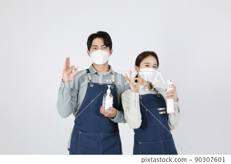 Asian Korean young man and woman startup concept_ holding disinfectant and doing ok Asian Korean young man and woman startup concept_ holding disinfectant and doing ok 90307601