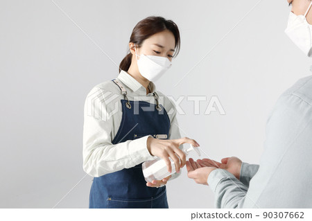 Asian Korean young man and woman startup concept_ sanitizing their hands Asian Korean young man and woman startup concept_ sanitizing their hands 90307662