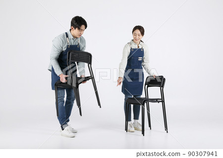 Asian Korean young man and woman startup concept_ tidying up their chairs Asian Korean young man and woman startup concept_ tidying up their chairs 90307941