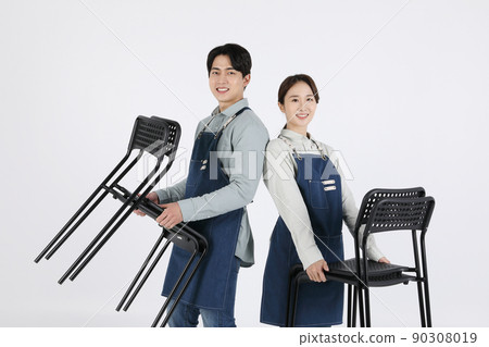Asian Korean young man and woman startup concept_ tidying up their chairs Asian Korean young man and woman startup concept_ tidying up their chairs 90308019