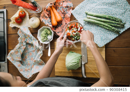 A lifestyle with eco-wrap and beeswax wrap at the hands of women who cook A lifestyle with eco-wrap and beeswax wrap at the hands of women who cook 90308415