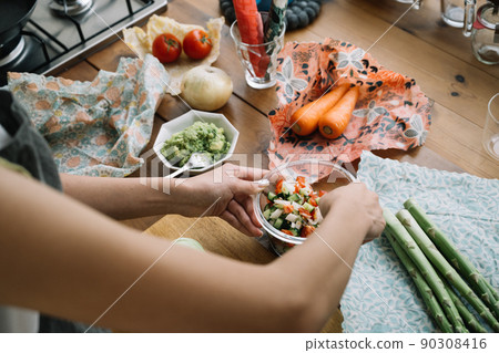A lifestyle with eco-wrap and beeswax wrap at the hands of women who cook A lifestyle with eco-wrap and beeswax wrap at the hands of women who cook 90308416