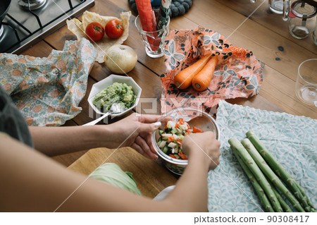 A lifestyle with eco-wrap and beeswax wrap at the hands of women who cook A lifestyle with eco-wrap and beeswax wrap at the hands of women who cook 90308417