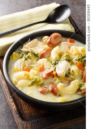 Chicken Sopas or Chicken Macaroni Soup Filipino Style close-up on a plate on the table. Vertical 90308445