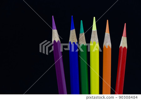 Crayon, a color symbol of LGBT pride, on a black background. 90308484