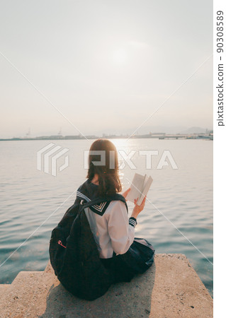 Schoolgirl in uniform and beautiful sunset sky 90308589