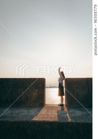 Schoolgirl in uniform and beautiful sunset sky 90308779