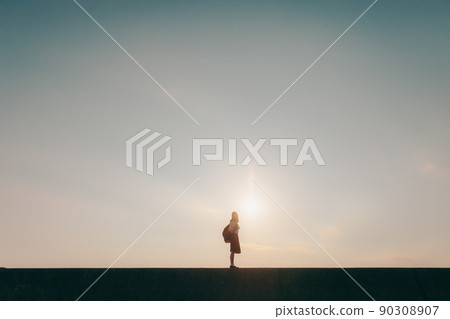 Schoolgirl in uniform and beautiful sunset sky 90308907