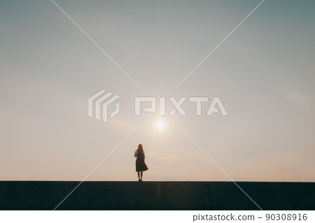 Schoolgirl in uniform and beautiful sunset sky 90308916