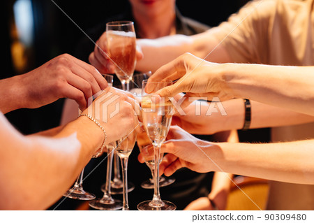 hands with glasses of champagne at the banquet. traditional toasts on holidays. hands with glasses of champagne at the banquet. traditional toasts on holidays. 90309480