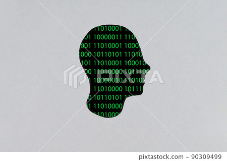 Silhouette of a human cardboard head cutout with a binary code made up of a set of green digits on a black background in its head Silhouette of a human cardboard head cutout with a binary code made up of a set of green digits on a black background in its head 90309499