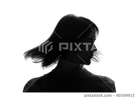 Silhouette of a woman shaking her hair Silhouette of a woman shaking her hair 90309915