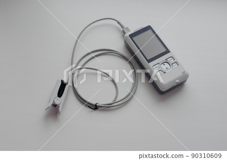 Pulse oximeter on a white background. Medical control and diagnostic device for measuring the saturation of capillary blood with oxygen 90310609